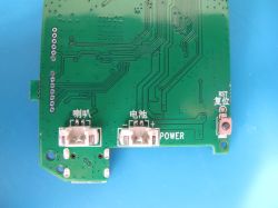 View of the bottom part of the circuit board with test point labels and buttons.
