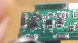 Close-up of a green PCB with SMD components and visible solder joints