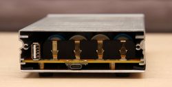 Rear view of the headphone amplifier case with visible USB socket and battery connectors.