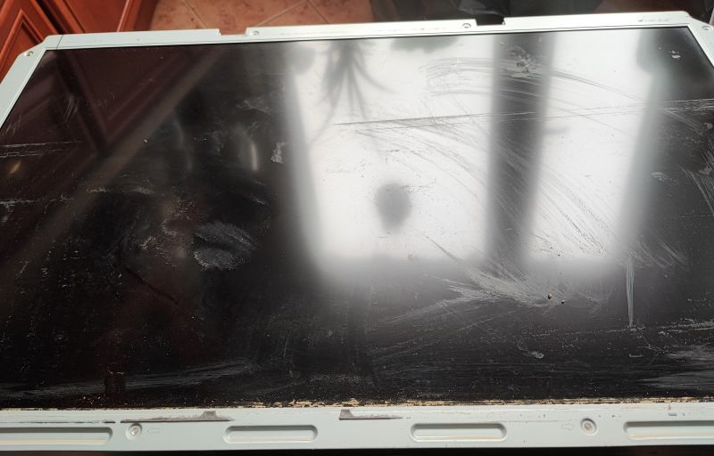 Flooded Samsung TV with a Dirty Screen Dirty television screen after flooding.