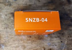 Sonoff SNZB-04 Sensor Box Orange box with white SNZB-04 text on the top edge.