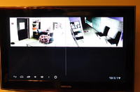 How can I stream footage from a camera at work to my TV at home via the internet?