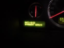 Car dashboard showing the message ANTI-SKID SERVICE REQUIRED.