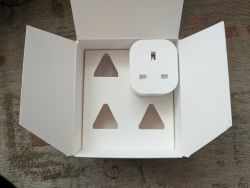 Plug in Cardboard Box Modern white plug in an open cardboard box