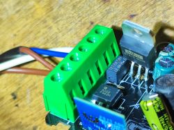 Close-up of a circuit with a BTA16-800B triac and capacitors on a PCB