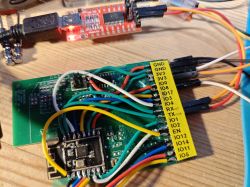 ESP module connected to USB-TTL adapter with multicolored jumper wires