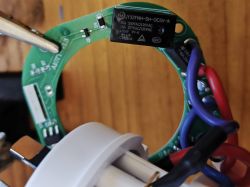 Printed Circuit Board with Electronic Component Printed circuit board with attached wires and an electronic component.