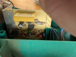 Electronic circuit board inside a device Circuit board with electronic components inside a green enclosure.