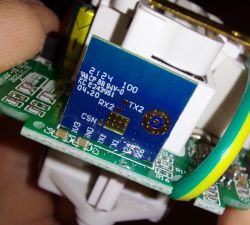 Close-up of a smart plug circuit board with a blue module.