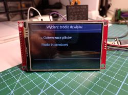 TFT display on a red PCB shows a menu: “Choose audio source” with file player and internet radio options.