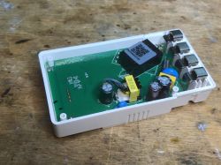 View of the interior of the Sonoff POWR316D module with electronic components on the PCB.