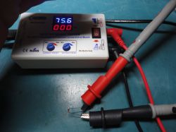 KT4H multimeter displaying 75.6 V with test leads connected to a component.