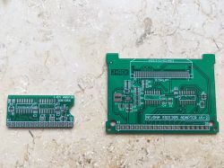 Two green printed circuit boards of different sizes on a light background.
