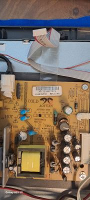 Close-up of a TV mainboard with visible labels and serial number.
