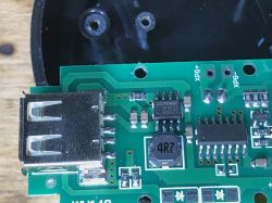 Zbliżenie na płytkę PCB w lampce kempingowej HC-261 z widocznymi elementami elektronicznymi.