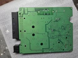 Green PCB underside with solder points and black connectors on the left side