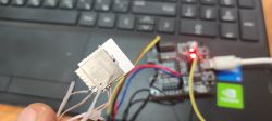 ESP32 module with wires and development board on a laptop ESP32 module with connected wires in front of a development board and laptop