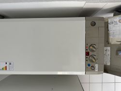 Close-up of the control panel of a Bosch Junkers gas boiler with knobs and a digital display.