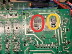 Circuit board with components marked in red and yellow.