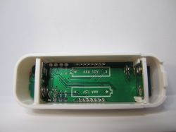 Interior of ZY-TH02Pro Electronic Device Interior view of an open electronic device with empty slots for AAA batteries and visible printed circuit board.