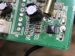Close-up of U1 integrated circuit on PCB with electronic components and unclear traces.