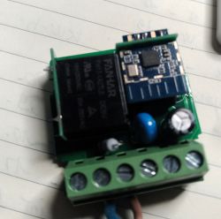 Electronic module with visible components on a sheet of paper.