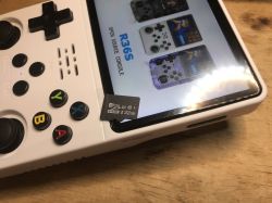 White R36S console with 32 GB microSD card inserted and game menu on screen