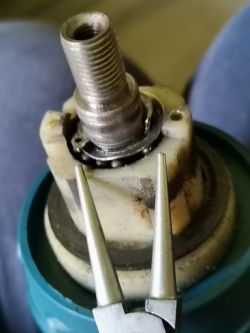 Close-up of a damaged drill chuck with an exposed circlip.