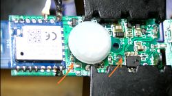 Close-up of a circuit board with electronic components and marked connection points.