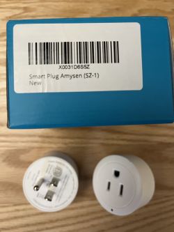 Amysen Smart Plug with Packaging Amysen smart plug and packaging on a wooden surface.