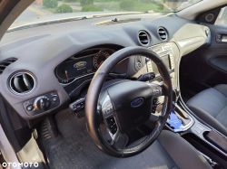 Interior of a Ford car with visible steering wheel, dashboard, and part of the center console.