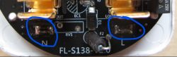 Inside View and Main Circuit Board of a Smart Plug Close-up of the main circuit board of a smart plug with highlighted solder points.