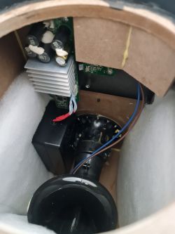 View of the interior of a housing with electronic components and a modified power supply.