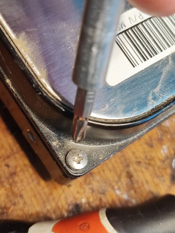 Unscrewing a Screw in a Hard Drive Close-up of a screwdriver unscrewing a screw in a hard drive.