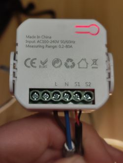 Close-up of an energy monitoring module with wire connections.