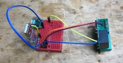 Circuit with wires connected to a red breadboard and USB module.