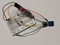 Microcontroller Module on Prototype Board Controller module mounted on a breadboard with wires and a USB programmer.