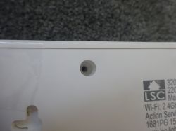 Non-standard Screw Hole in LSC Power Strip Close-up of the LSC Smart Connect power strip casing with a small hole for a non-standard screw.