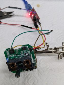 The image shows an open smart plug with visible solder joints and wires.