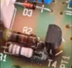 Circuit board with visible resistor R2 with colored bands and other components.