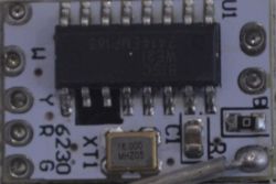 Close-up of an electronic module with a visible integrated circuit and soldered components.