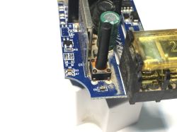 Flooded WiFi Relay BW-SS1 Close-up of a flooded electronic relay with signs of corrosion on the button.
