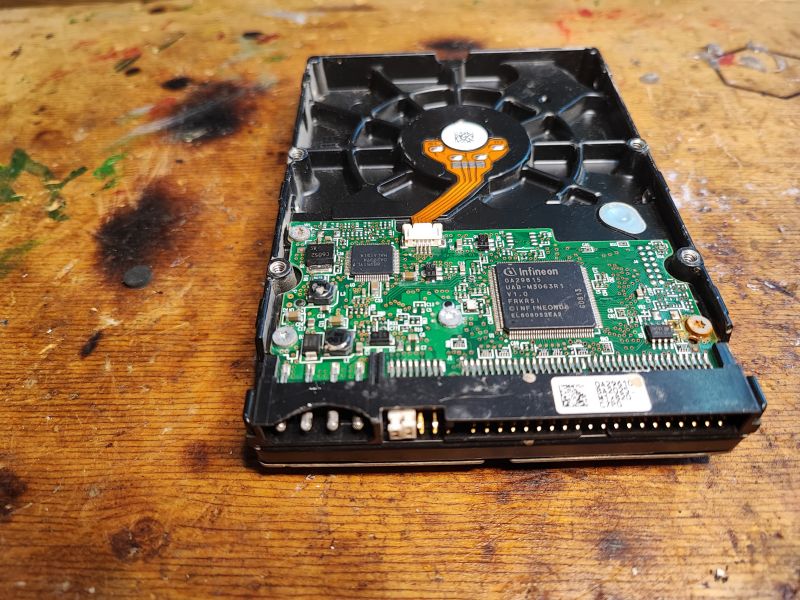 Interior of Hitachi Hard Drive with Electronics Photo of the interior of a Hitachi hard drive with electronics on the PCB.