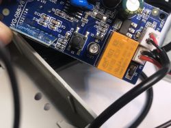 ATLO-GDC2-TUYA Garage Door Controller Circuit Board with Relay Close-up of the ATLO-GDC2-TUYA garage door controller circuit board with a visible HUI KE relay and connected wires.
