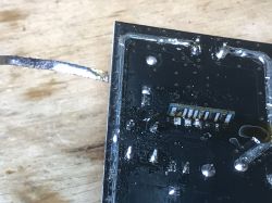 FL-S63-V1.0 PCB with soldered wires on a wooden background.