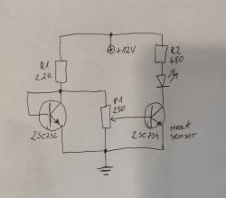 Electrical schematic with two transistors and an LED.