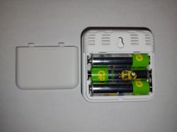 Open back of a sensor with three AA batteries.