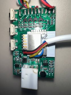 LED controller PCB with multiple soldered colored wires, a visible microphone, and a white connector.
