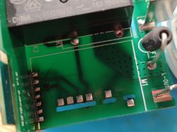 Close-up of PCB showing relay, pin header, and WiFiBoard V1.6 marking