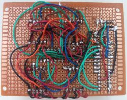 Perfboard with hand-soldered wires in various colors